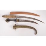 A Jambiya short sword, with a brass inlaid horn handle and leather sheath, inscription to the blade,