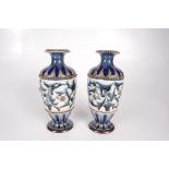 A pair of Doulton Lambeth stoneware vases, with scrolling leaf decoration, signed EW to base,