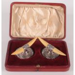 A pair of Victorian silver knife rests with ivory horns and fluted bases, Sheffield 1898, cased.