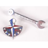 A 1951 Festival of Britain souvenir enamelled brooch and a Bedford Tools advertising tie clip in