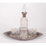 A silver mounted decanter on a plated tray by Hukin & Heath,