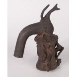 An African bronze pipe, in the form of an elephant's head, the bowl with three seated musicians,