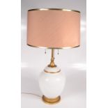 A gilt metal and milk glass table lamp,