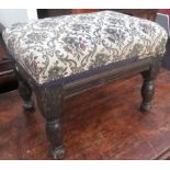 A footstool made from a 17th century joint stool, the legs reduced, the top removed and upholstered.