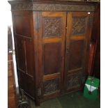 An oak hall cupboard in 17th century style of joined construction.