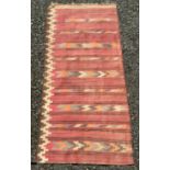 A Persian kelim rug, decorated with horizontal geometric bands, 241 x 112cm.