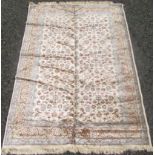 A machine made rug, the ivory field with an all over design of scrolling vines and leaves,
