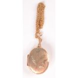 A 9ct gold engraved post war locket on gold chain, 13g.
