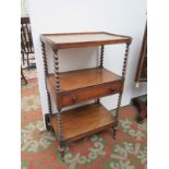 A Victorian walnut three tier whatnot, with barley twist supports and a central drawer stamped 'M.