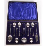 An unusual late Victorian set of six silver teaspoons, matching tongs, butter knife,