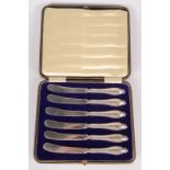 A set of six cake knives with filled silver handles, cased.