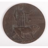 A WWI bronze death plaque, named Reginald Charles Ennor, diameter 12cm.