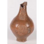 A brown salt glazed stoneware bellarmine jug, 17th century, the neck moulded with a bearded mask,