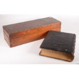 A black leather bound Holy Bible, 32 x 26cm and a pine box, height 13.3cm, width 54.2cm, depth 18.
