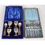 A set of four egg cups and matching spoons, cased, together with six cake forks, cased.