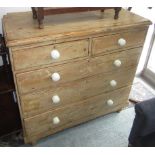 A Victorian pine chest of drawers, with two short and three long drawers on turned feet,