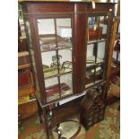 An Edwardian mahogany display cabinet, with a pair of glazed doors,