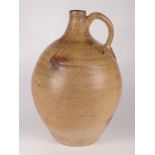 A large beige salt glazed stoneware bellarmine jug, 17th/18th century, height 44cm, width 27cm.