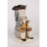 A Staffordshire pearlware toby jug, early 19th century, decorated in Pratt type glazes,