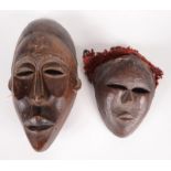 Two African tribal wooden masks, 29.5 x 16cm and 18 x 14cm.