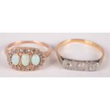 A gold ring set an oval cluster with three opals surrounded by small diamonds and one other gold