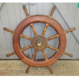 A mahogany and brass bound ships wheel, with eight turned spokes, diameter 107cm.