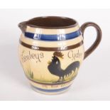 A Longpark Torquay pottery Mottoware jug, inscribed 'Henleys Cyder of the walk,