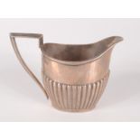 A silver Walker & Hall half fluted milk jug, 5.9oz.