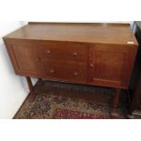 An Arts and Crafts oak sideboard, with two central doors flanked by a pair of cupboard doors,