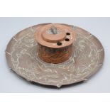 A Newlyn copper inkwell, repousse decorated with stylised fish, diameter 20cm.