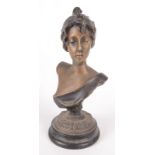 A bronze female bust, late 19th/early 20th century on a circular ebonised plinth base, height 22cm,