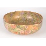 A Japanese Satsuma pottery bowl, 19th century, gilt decorated with birds, flowers and trees,