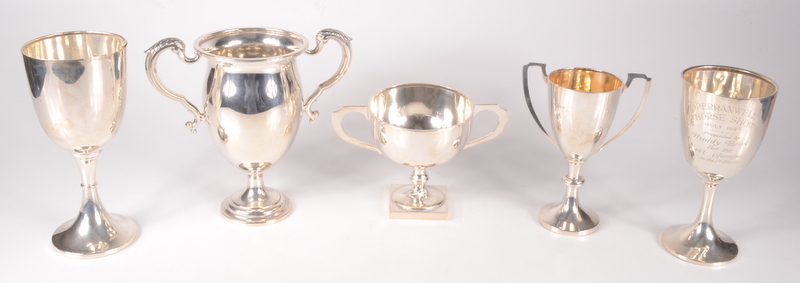 A Mappin & Webb silver twin handled cup, together with four other silver cups, 25.2oz.