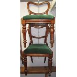 A pair of early Victorian balloon back mahogany dining chairs with turned fluted legs.