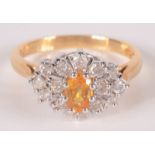 An 18ct gold ring set a marquise cluster with a yellow sapphire at the centre surrounded by