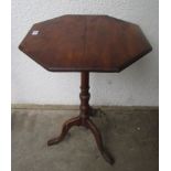 A Victorian walnut tripod table, the octagonal top on a turned stem,