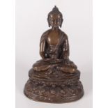 A South East Asian bronze figure of a seated man, 19th century, on an oval base, height 20cm,