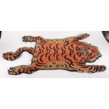A Tibetan tiger rug, length 94cm, width 52cm.