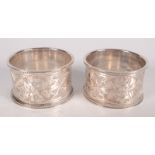 A pair of engraved and beaded Edwardian silver napkin rings, Birmingham 1905, cased.