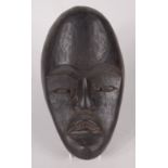 An African carved wood mask, height 28cm, width 17cm.