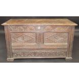 An unusual 17th century carved oak joined mule chest with plain planked lid.