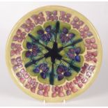 A Moorcroft pottery 'Violet' pattern plate, shape 783, by Sally Tuffin,