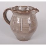 A David Leach tin glazed jug, with vertical line decoration, impressed personal seal, height 11.