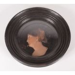A Victorian wax silhouette portrait of a lady, in a circular ebonised frame, diameter 17cm.