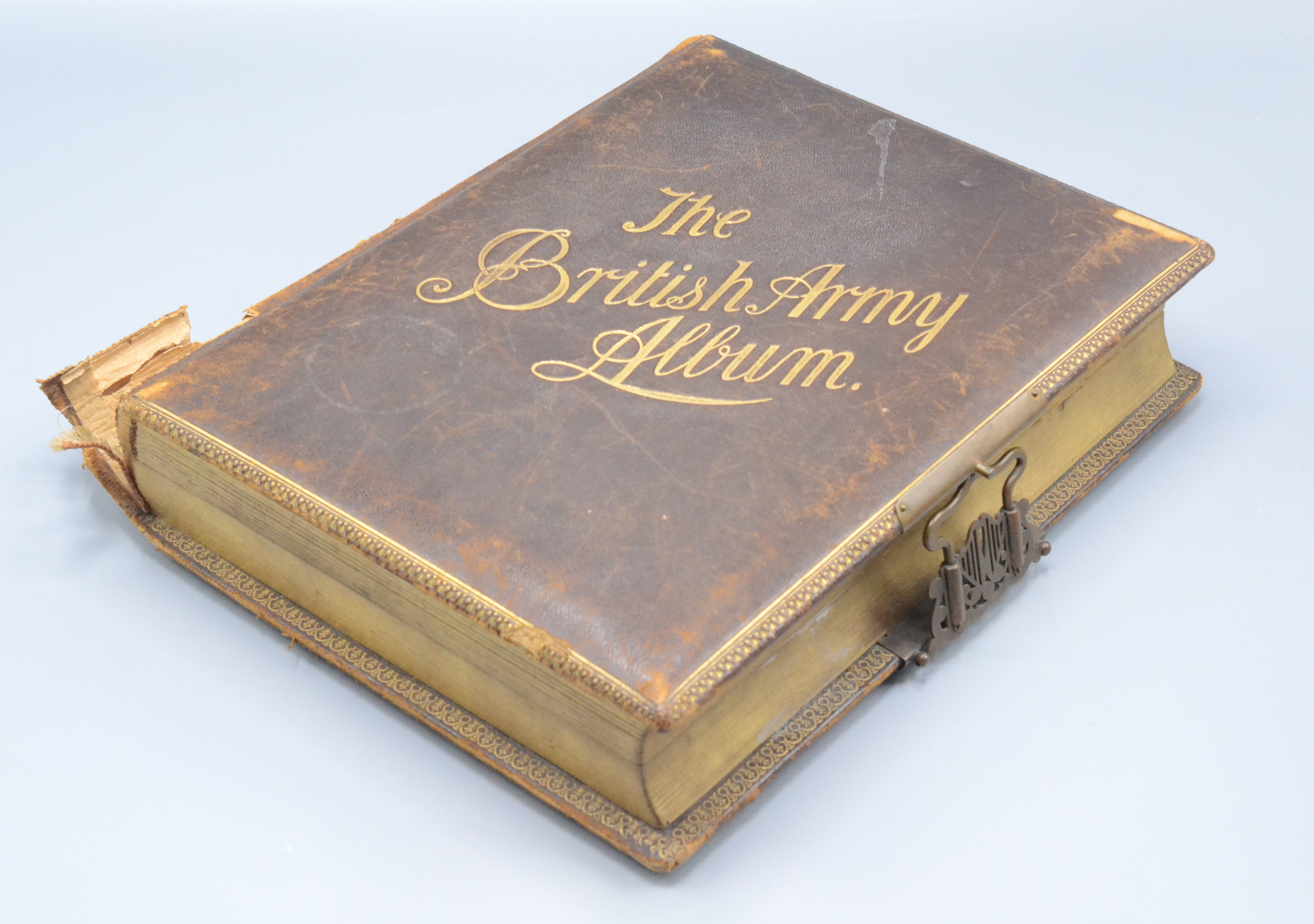 A leather and gilt tooled musical photograph album, 'The British Army Album', dated 21/10/90,