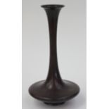 A Japanese bronze vase, the flared rim above a slender narrow neck and squat body, height 31cm,