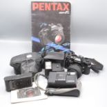 A Pentax Super F1 camera, with a AF200T flash unit and booklets,