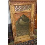 An Indian carved hardwood mirror,