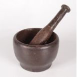 A cast iron pestle and mortar, length of pestle 21cm, mortar height 9.5cm, diameter 13.5cm.
