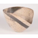 A studio pottery bowl, the cream speckled ground with grey abstract decoration,